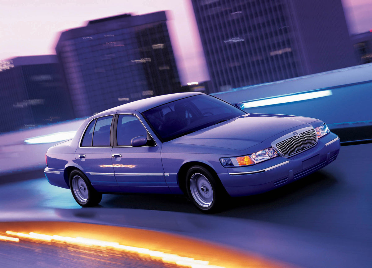 This archival image documents the 2002 Ford Grand Marquis action shot on scenic road with cityscape MS604778 and is preserved in the Ford Heritage Vault as part of Ford Motor Company's historic photographic archive. Free for personal, non-commerci...