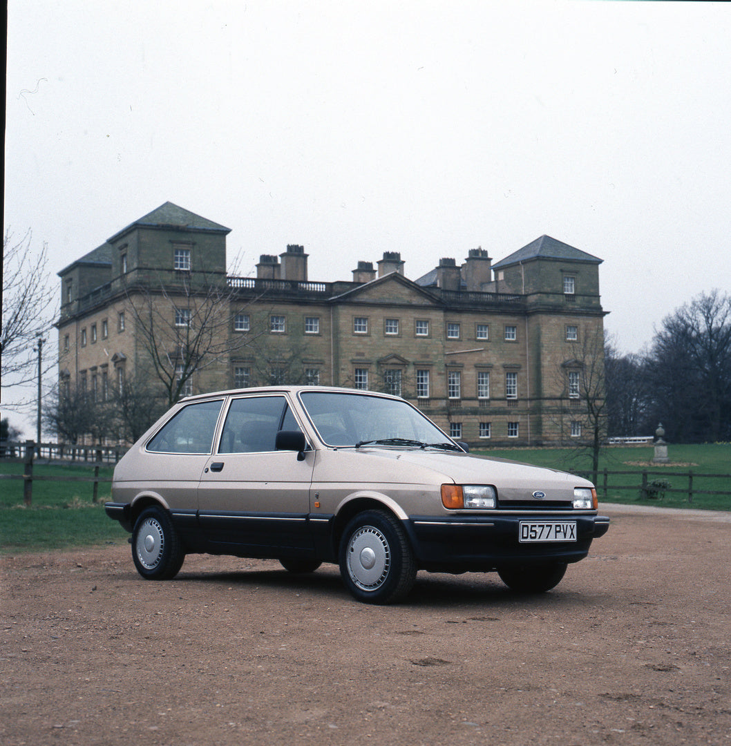 This archival image documents the 1987 Ford Fiesta Mark II CTX 1.1 Ghia in front of scenic mansion and is preserved in the Ford Heritage Vault as part of Ford Motor Company's historic photographic archive. Free for personal, non-commercial use. Fo...