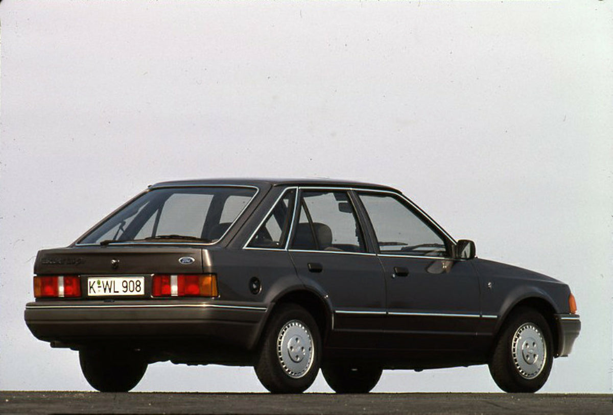 This archival image documents the 1986 Ford Escort Mark IV rear view with scenic blue sky and is preserved in the Ford Heritage Vault as part of Ford Motor Company's historic photographic archive. Free for personal, non-commercial use. Ford Herita...
