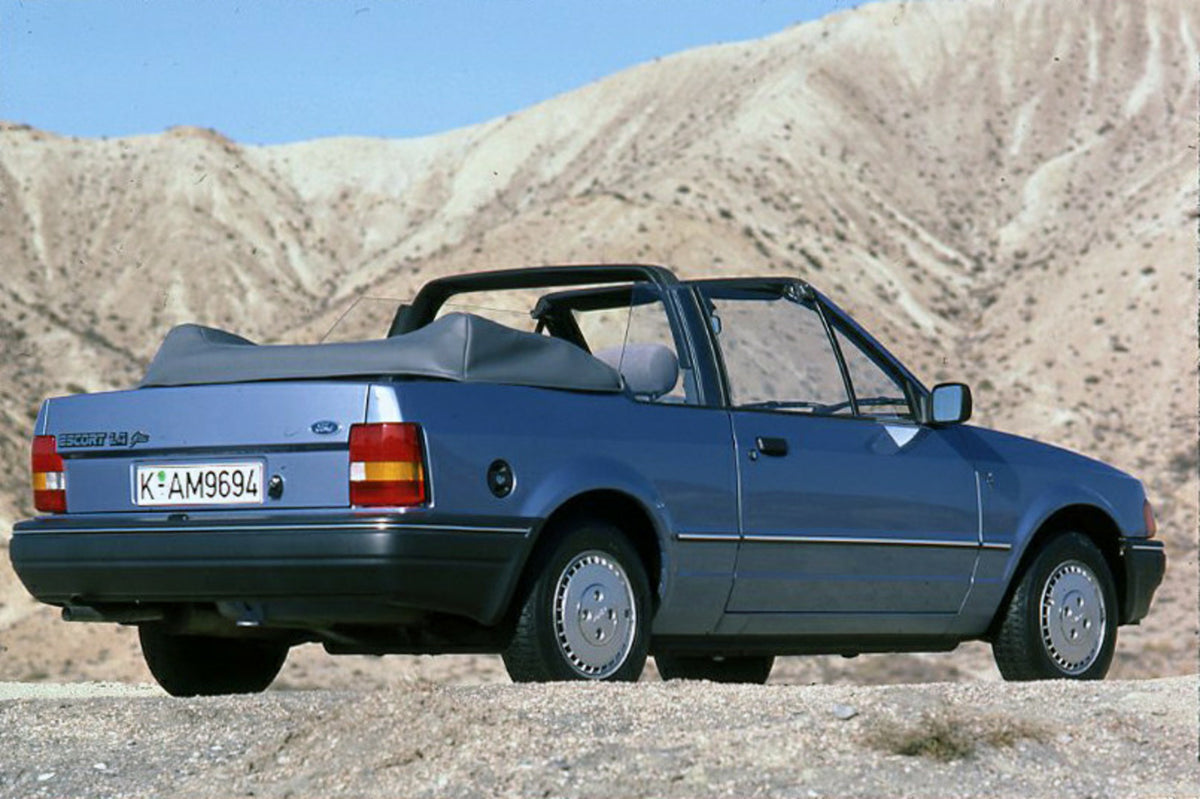 This archival image documents the 1986 Ford Escort Mark IV 1.6 Ghia Cabriolet rear view with scenic hills and is preserved in the Ford Heritage Vault as part of Ford Motor Company's historic photographic archive. Free for personal, non-commercial ...