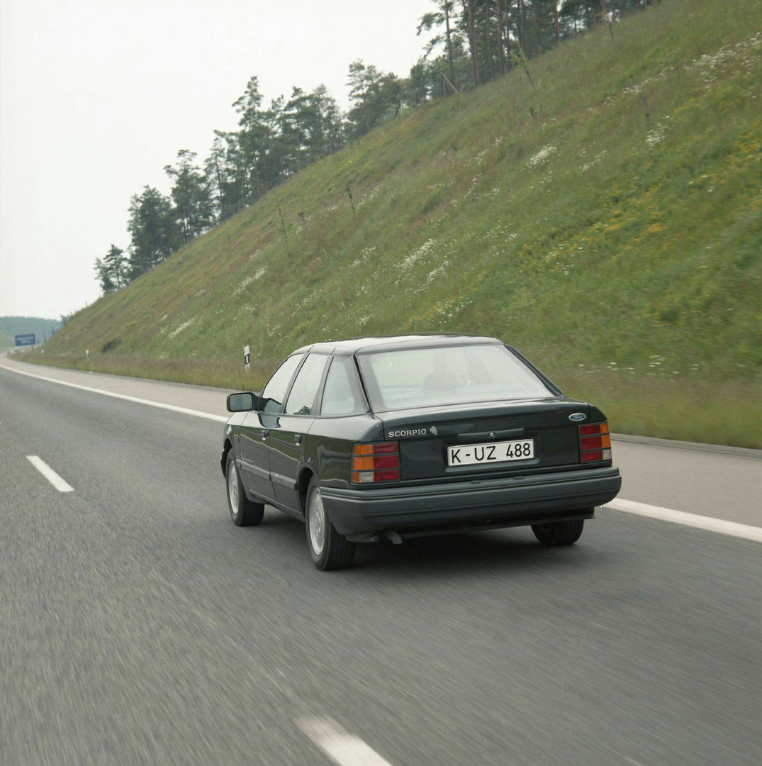 This archival image documents the 1985 Ford Scorpio Mark I 4 Wheel Drive LHD rear view action shot on scenic road and is preserved in the Ford Heritage Vault as part of Ford Motor Company's historic photographic archive. Free for personal, non-com...