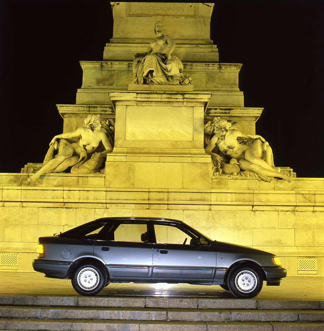 This archival image documents the 1985 Ford Scorpio Mark I side view in front of statue in Bordeaux and is preserved in the Ford Heritage Vault as part of Ford Motor Company's historic photographic archive. Free for personal, non-commercial use. F...