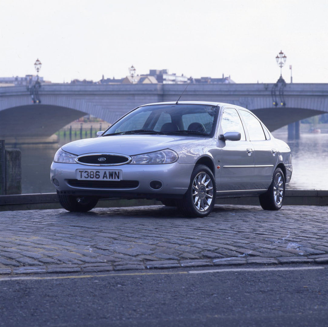 This archival image documents the 1999 Ford Mondeo Mark I Ghia X with scenic river and bridge and is preserved in the Ford Heritage Vault as part of Ford Motor Company's historic photographic archive. Free for personal, non-commercial use. Ford He...