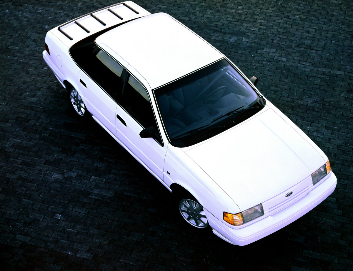 This archival image documents the 1991 Ford Taurus four-door and is preserved in the Ford Heritage Vault as part of Ford Motor Company's historic photographic archive. Free for personal, non-commercial use. Ford Heritage Vault reference AR-2001-94...