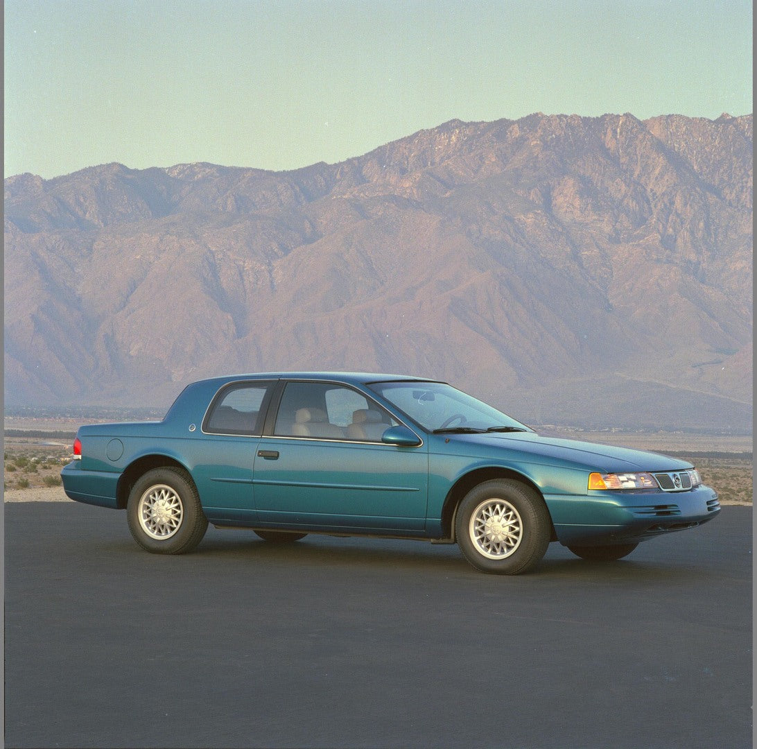 This archival image documents the 1994 Mercury Cougar side view with mountains in background AR-2002-213709 and is preserved in the Ford Heritage Vault as part of Ford Motor Company's historic photographic archive. Free for personal, non-commercia...