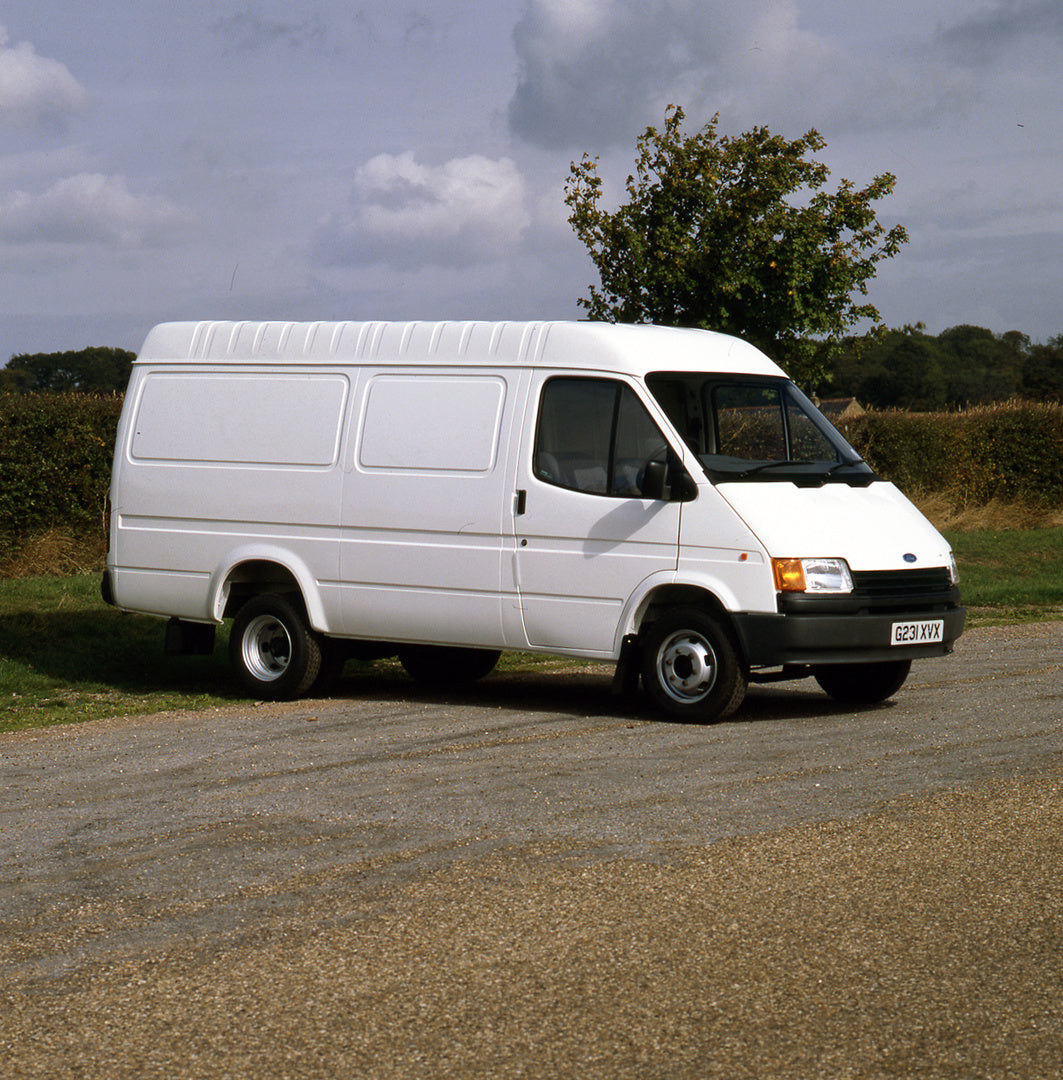 This archival image documents the 1989 Ford Transit Mark III Van 190 Long Wheel Base on scenic road with tree and is preserved in the Ford Heritage Vault as part of Ford Motor Company's historic photographic archive. Free for personal, non-commerc...