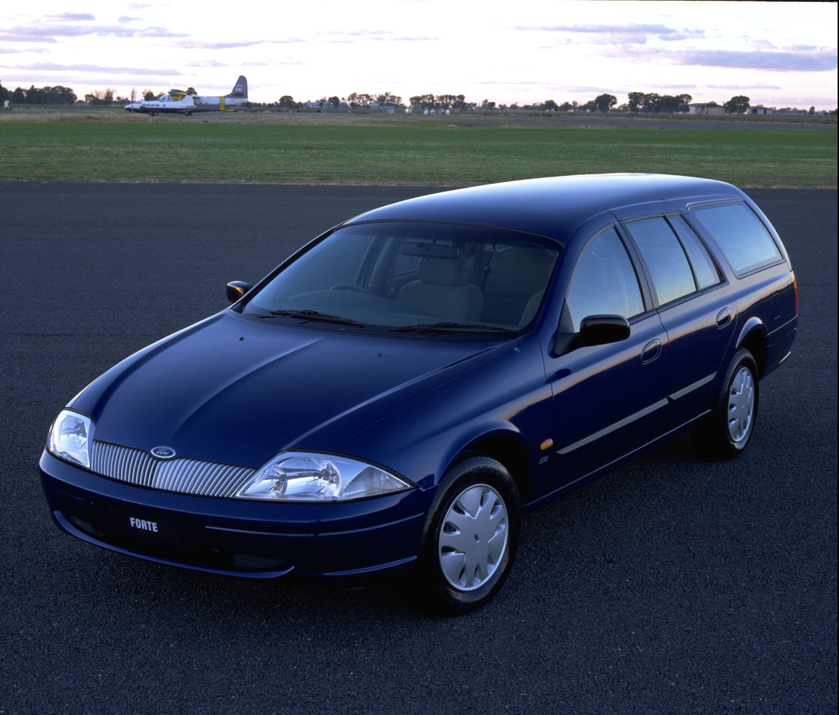 This archival image documents the 1998 Ford Falcon Forte on scneic road with trees and plane in distance and is preserved in the Ford Heritage Vault as part of Ford Motor Company's historic photographic archive. Free for personal, non-commercial u...