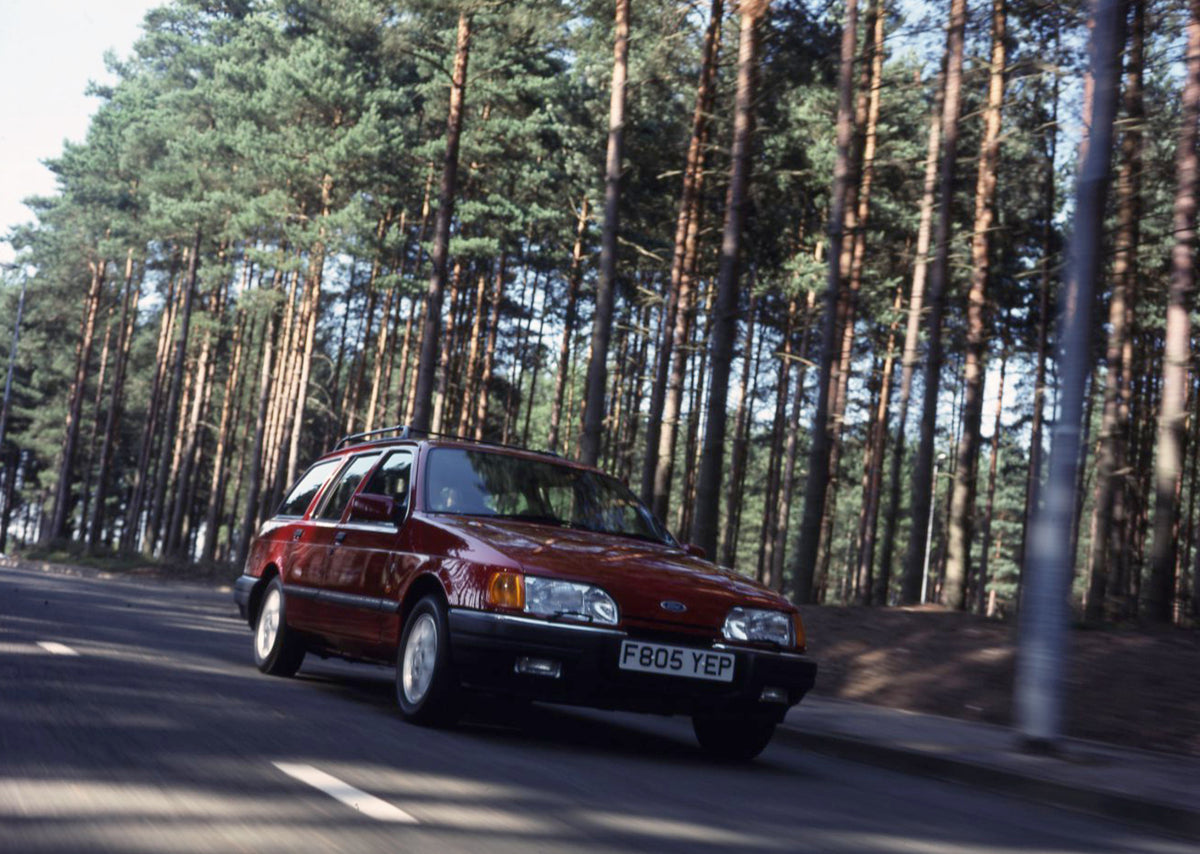 This archival image documents the 1988 Ford Sierra Mark II Estate 4x4 action shot on scenic forest road and is preserved in the Ford Heritage Vault as part of Ford Motor Company's historic photographic archive. Free for personal, non-commercial us...