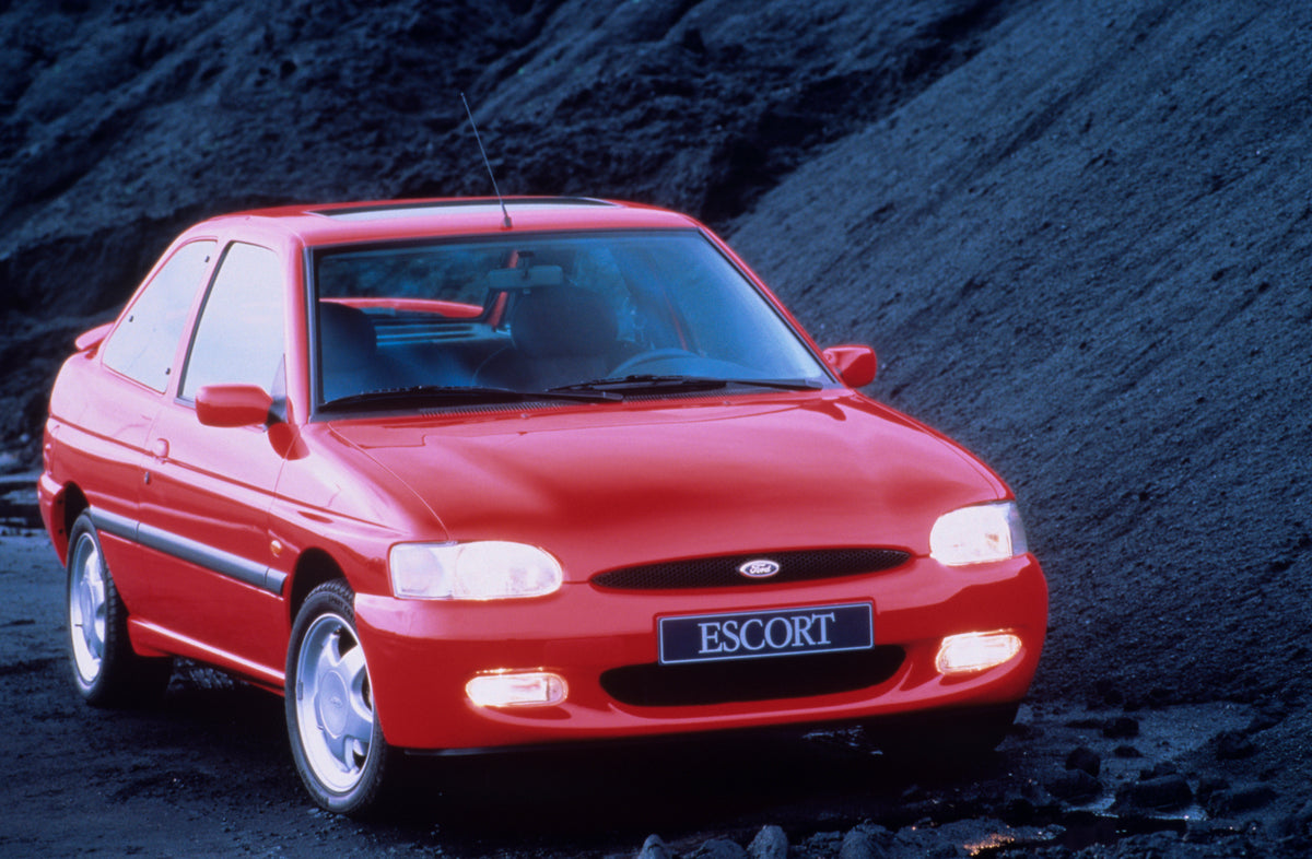 This archival image documents the 1995 Ford Escort Mark V RS2000 closeup with scenic rock formation and is preserved in the Ford Heritage Vault as part of Ford Motor Company's historic photographic archive. Free for personal, non-commercial use. F...