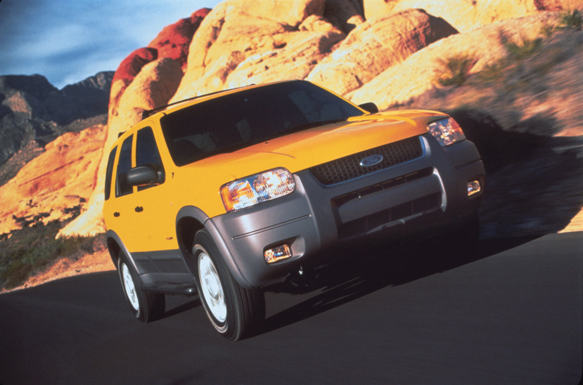 This archival image documents the 2001 Ford Escape with mountains in background and is preserved in the Ford Heritage Vault as part of Ford Motor Company's historic photographic archive. Free for personal, non-commercial use. Ford Heritage Vault r...
