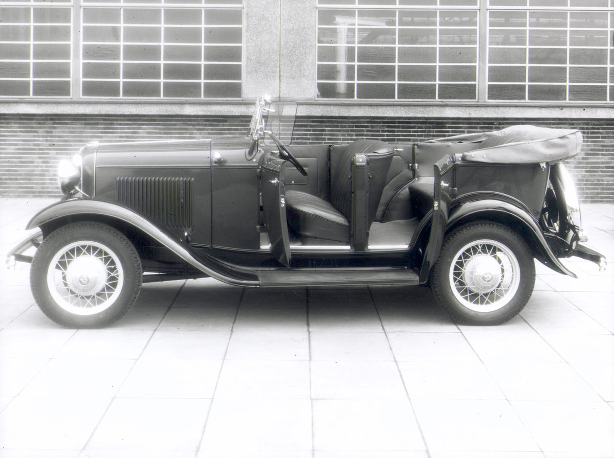 This archival image documents the 1932 Ford V8 side view with open doors and is preserved in the Ford Heritage Vault as part of Ford Motor Company's historic photographic archive. Free for personal, non-commercial use. Ford Heritage Vault referenc...