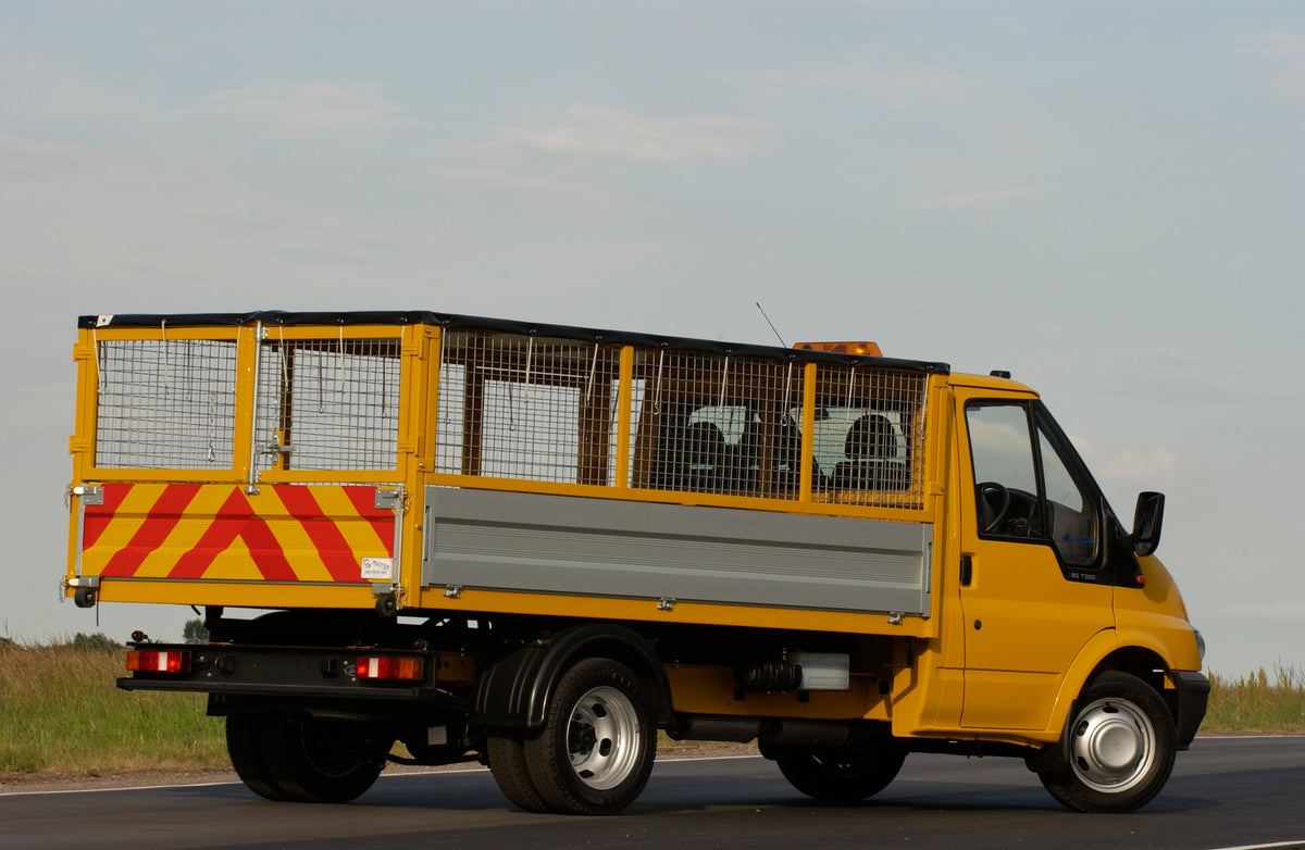 This archival image documents the 2003 Ford Transit Mark IV conversion with wire container rear view on scenic road and is preserved in the Ford Heritage Vault as part of Ford Motor Company's historic photographic archive. Free for personal, non-c...