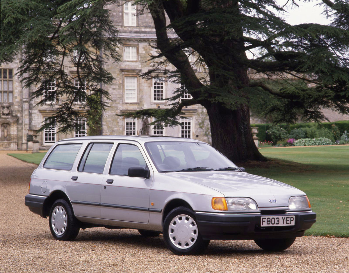 This archival image documents the 1988 Ford Sierra Mark II Estate in front of scenic house with trees and is preserved in the Ford Heritage Vault as part of Ford Motor Company's historic photographic archive. Free for personal, non-commercial use....