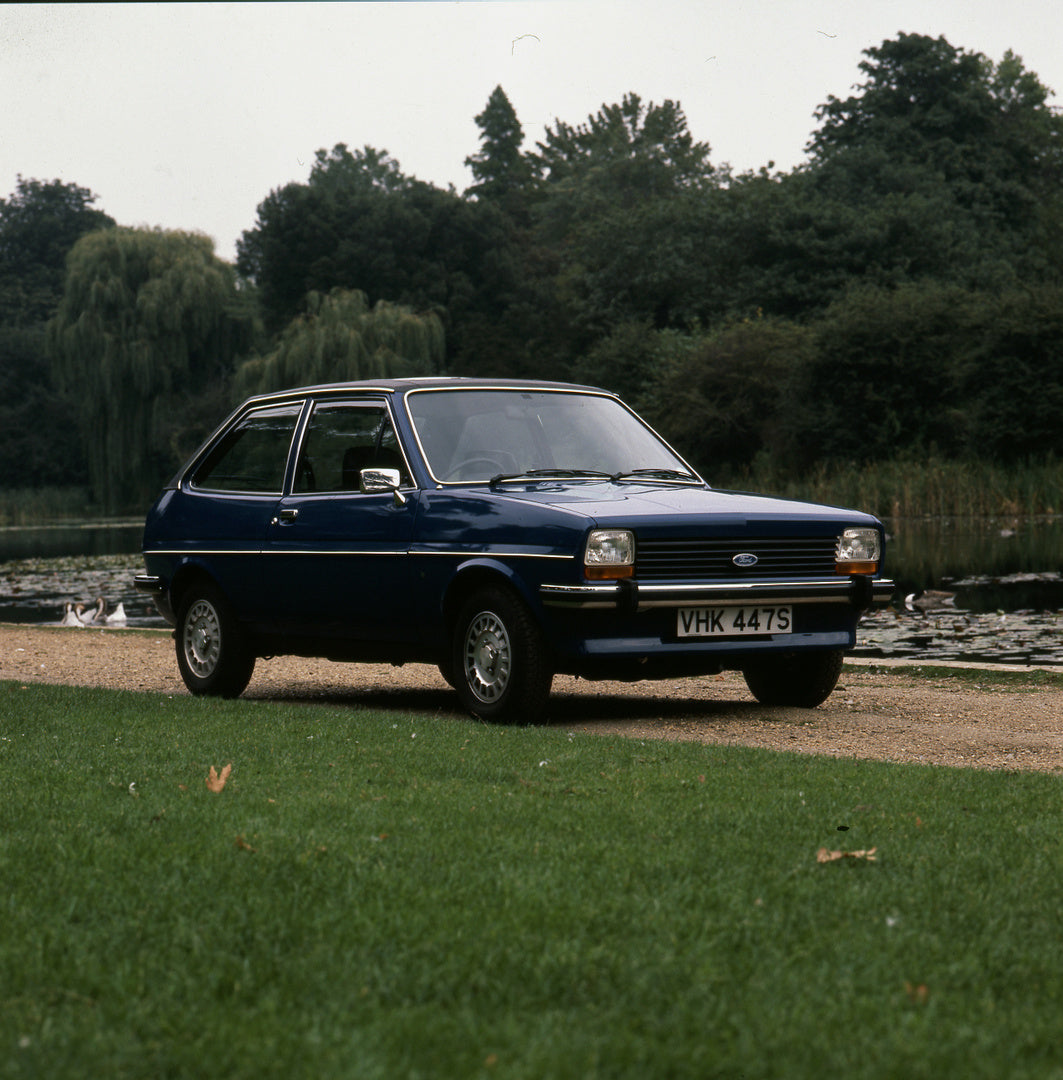 This archival image documents the 1977 Ford Fiesta Mark I Ghia 1.3 with scenic lake and trees and is preserved in the Ford Heritage Vault as part of Ford Motor Company's historic photographic archive. Free for personal, non-commercial use. Ford He...
