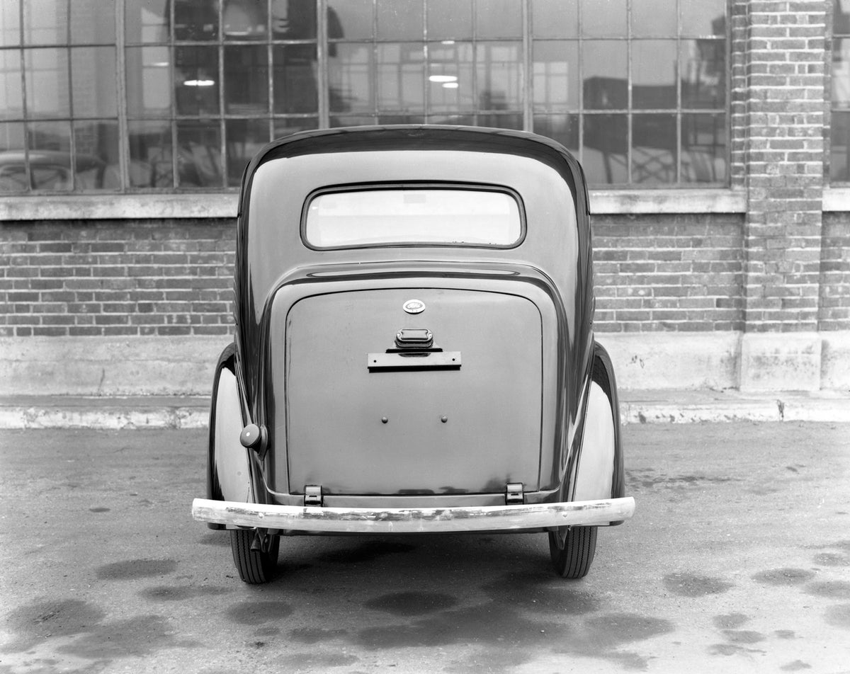 This archival image documents the 1946 Ford Anglia E04A rear view and is preserved in the Ford Heritage Vault as part of Ford Motor Company's historic photographic archive. Free for personal, non-commercial use. Ford Heritage Vault reference AR-20...