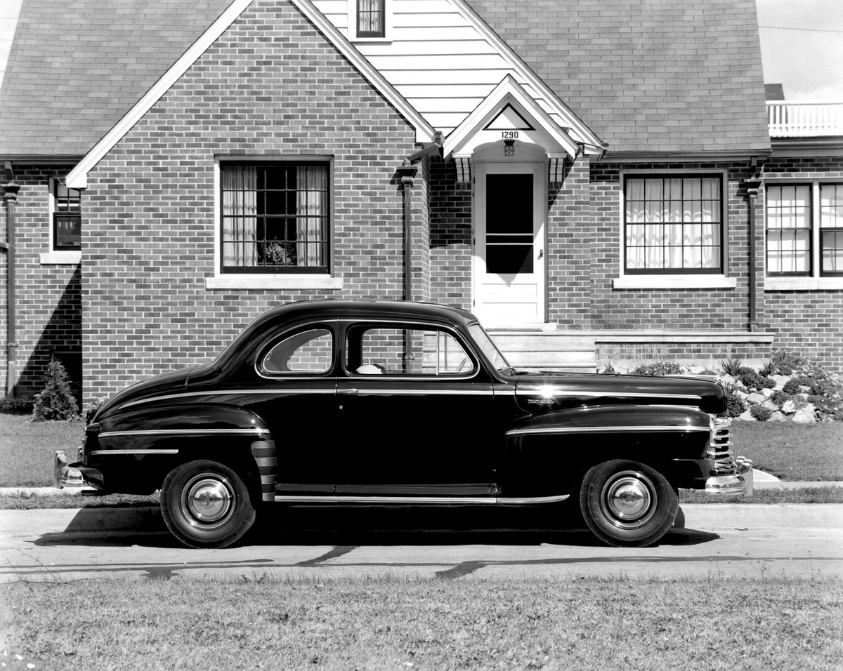 This archival image documents the 1946 Monarch Coupe side view in front of house AR-2007-5 and is preserved in the Ford Heritage Vault as part of Ford Motor Company's historic photographic archive. Free for personal, non-commercial use. Ford Herit...
