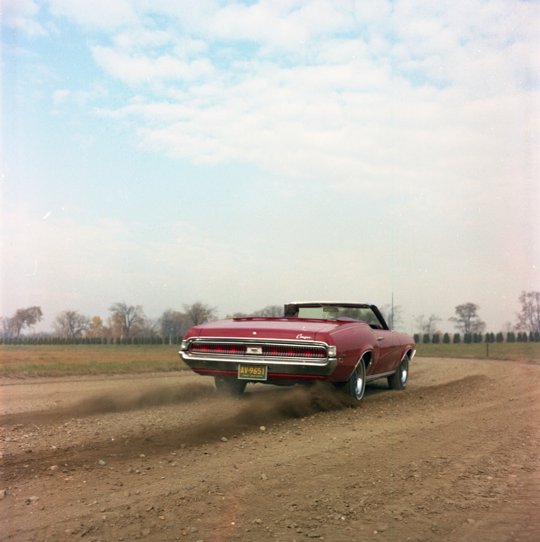 This archival image documents the 1969 Mercury Cougar convertible on Dirt Road and is preserved in the Ford Heritage Vault as part of Ford Motor Company's historic photographic archive. Free for personal, non-commercial use. Ford Heritage Vault re...