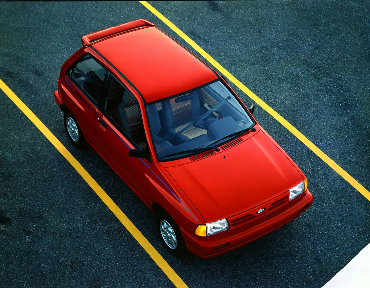 This archival image documents the 1991 Ford Festiva two-door and is preserved in the Ford Heritage Vault as part of Ford Motor Company's historic photographic archive. Free for personal, non-commercial use. Ford Heritage Vault reference AR-2001-94...