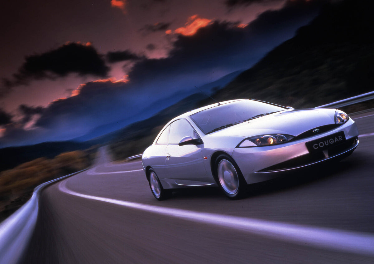 This archival image documents the 1998 Ford Cougar front 3/4 view on road 1998-73 and is preserved in the Ford Heritage Vault as part of Ford Motor Company's historic photographic archive. Free for personal, non-commercial use. Ford Heritage Vault...