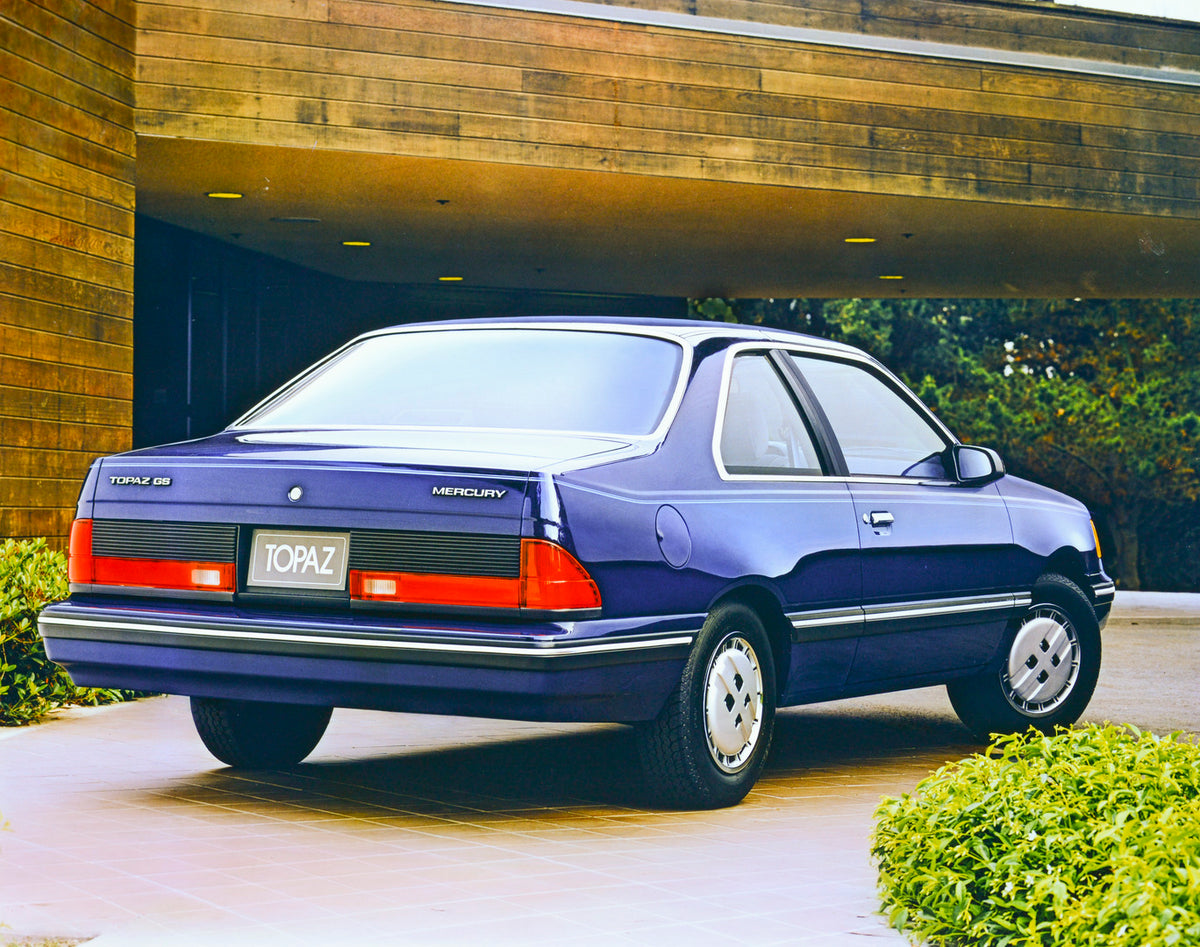 This archival image documents the 1986 Mercury Topaz GS two-door rear view and is preserved in the Ford Heritage Vault as part of Ford Motor Company's historic photographic archive. Free for personal, non-commercial use. Ford Heritage Vault refere...