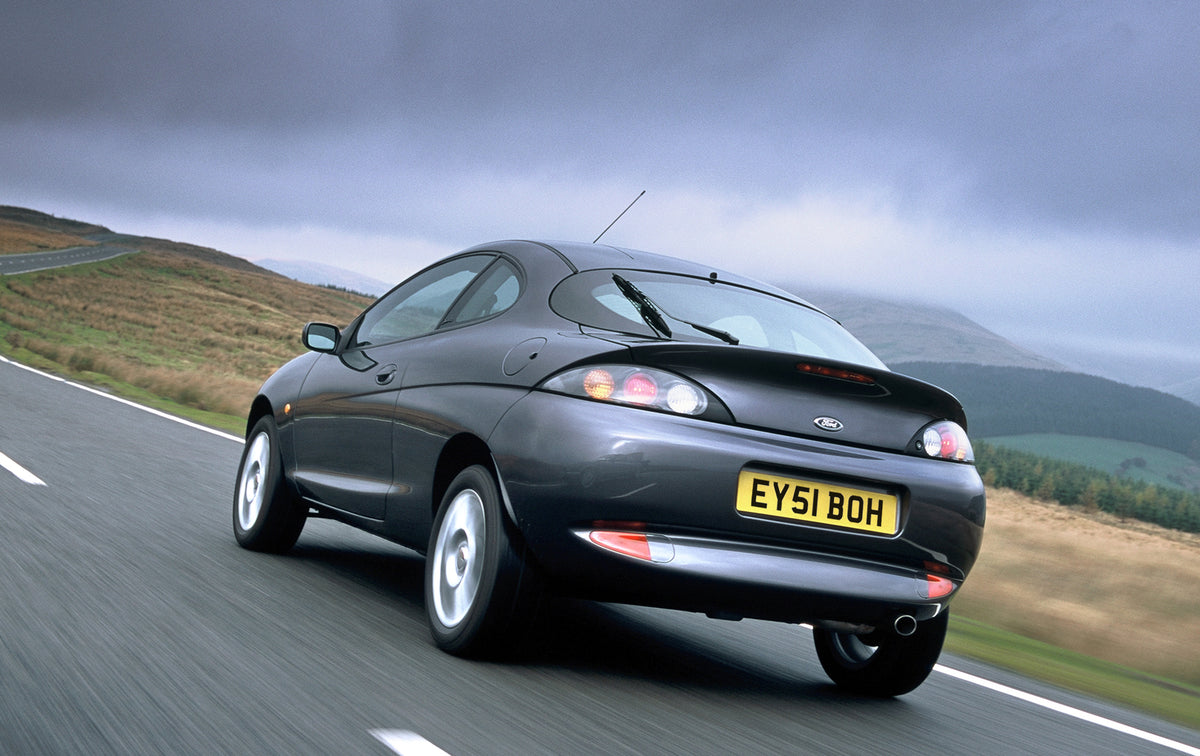 This archival image documents the 2001 Ford Puma Thunder rear view action shot on scenic road and is preserved in the Ford Heritage Vault as part of Ford Motor Company's historic photographic archive. Free for personal, non-commercial use. Ford He...