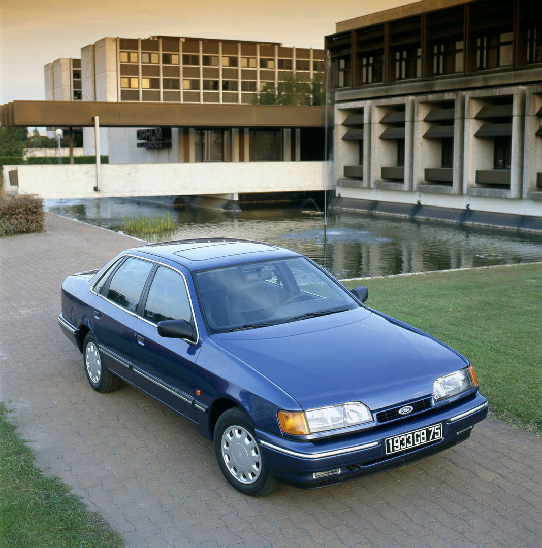 This archival image documents the 1989 Ford Scorpio Mark I front view near scenic building and is preserved in the Ford Heritage Vault as part of Ford Motor Company's historic photographic archive. Free for personal, non-commercial use. Ford Herit...