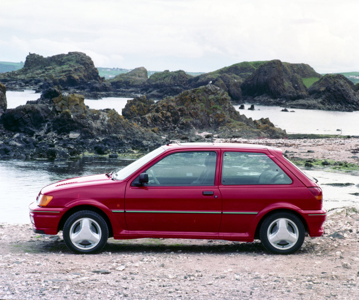 This archival image documents the 1990 Ford Fiesta Mark III Turbo on scenic rocky beach in Northern Ireland and is preserved in the Ford Heritage Vault as part of Ford Motor Company's historic photographic archive. Free for personal, non-commercia...