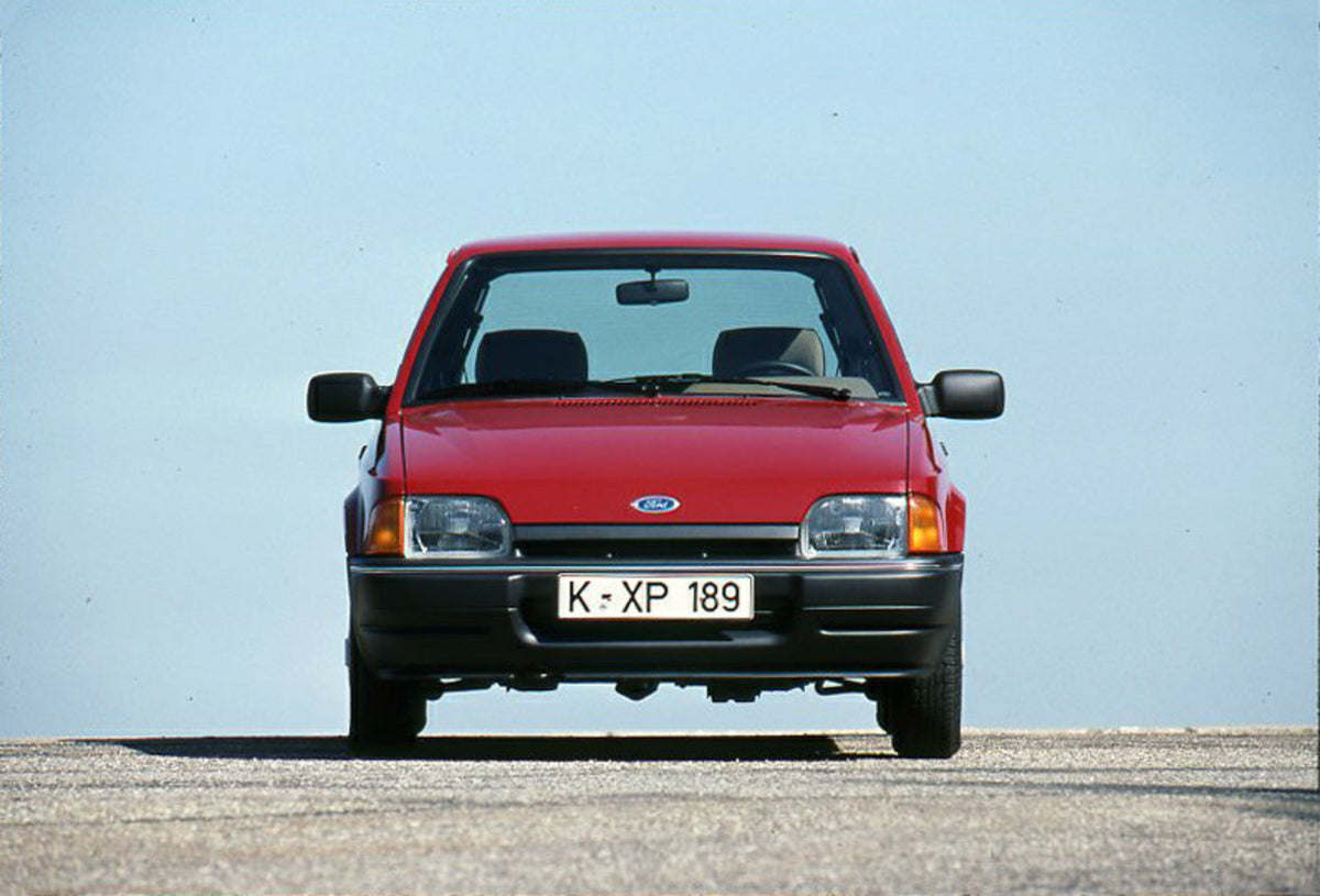 This archival image documents the 1989 Heritage Archive - 1988 Ford Escort Mark IV front view with scenic blue sky and is preserved in the Ford Heritage Vault as part of Ford Motor Company's historic photographic archive. Free for personal, non-co...