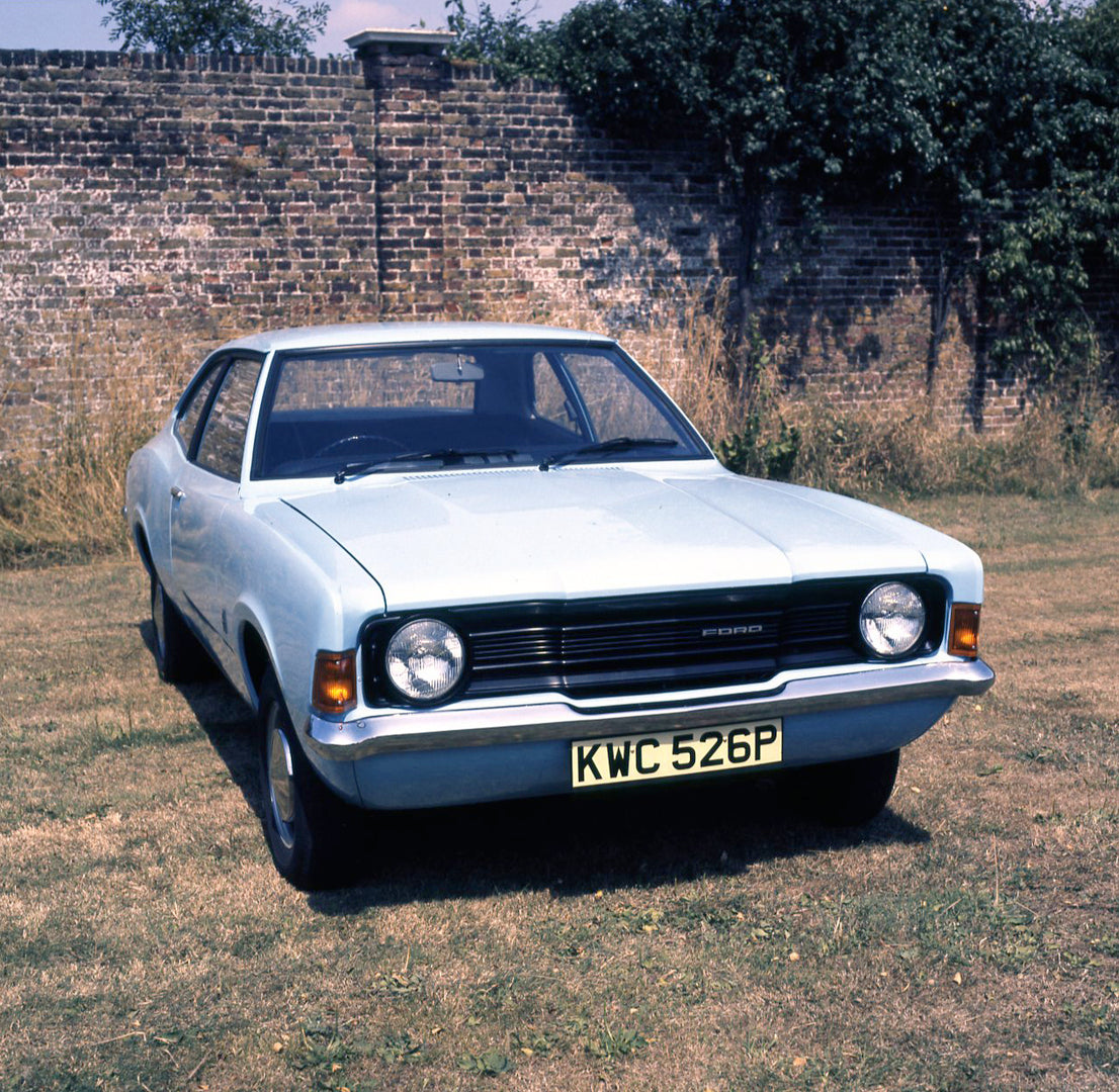 This archival image documents the 1975 Ford Cortina 1.3 Base MK III 2 door by scenic wall with shrubs and is preserved in the Ford Heritage Vault as part of Ford Motor Company's historic photographic archive. Free for personal, non-commercial use....
