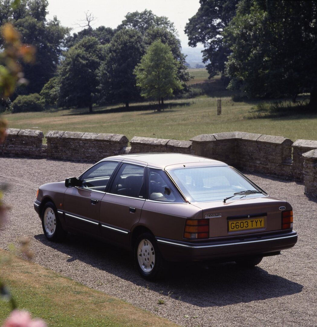This archival image documents the 1989 Ford Granada Scorpio Mark III rear view on scenic road and is preserved in the Ford Heritage Vault as part of Ford Motor Company's historic photographic archive. Free for personal, non-commercial use. Ford He...