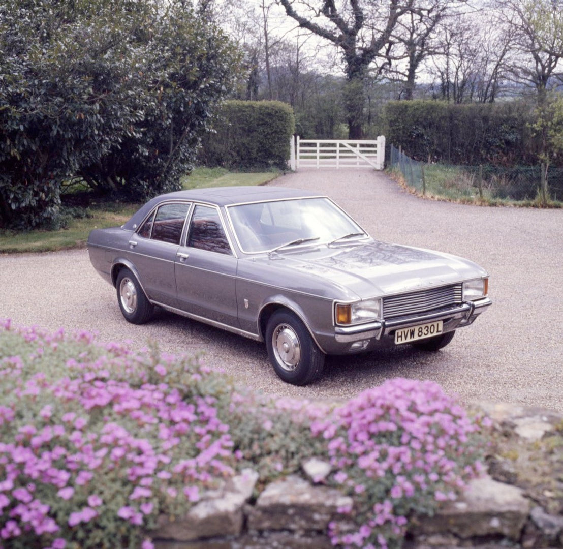 This archival image documents the 1972 Ford Granada Mark I GXL in scenic driveway with flowers and is preserved in the Ford Heritage Vault as part of Ford Motor Company's historic photographic archive. Free for personal, non-commercial use. Ford H...