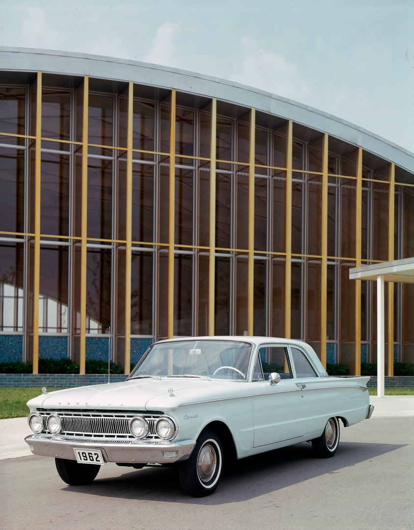This archival image documents the 1962 Mercury Comet two-door sedan in Front of Building and is preserved in the Ford Heritage Vault as part of Ford Motor Company's historic photographic archive. Free for personal, non-commercial use. Ford Heritag...