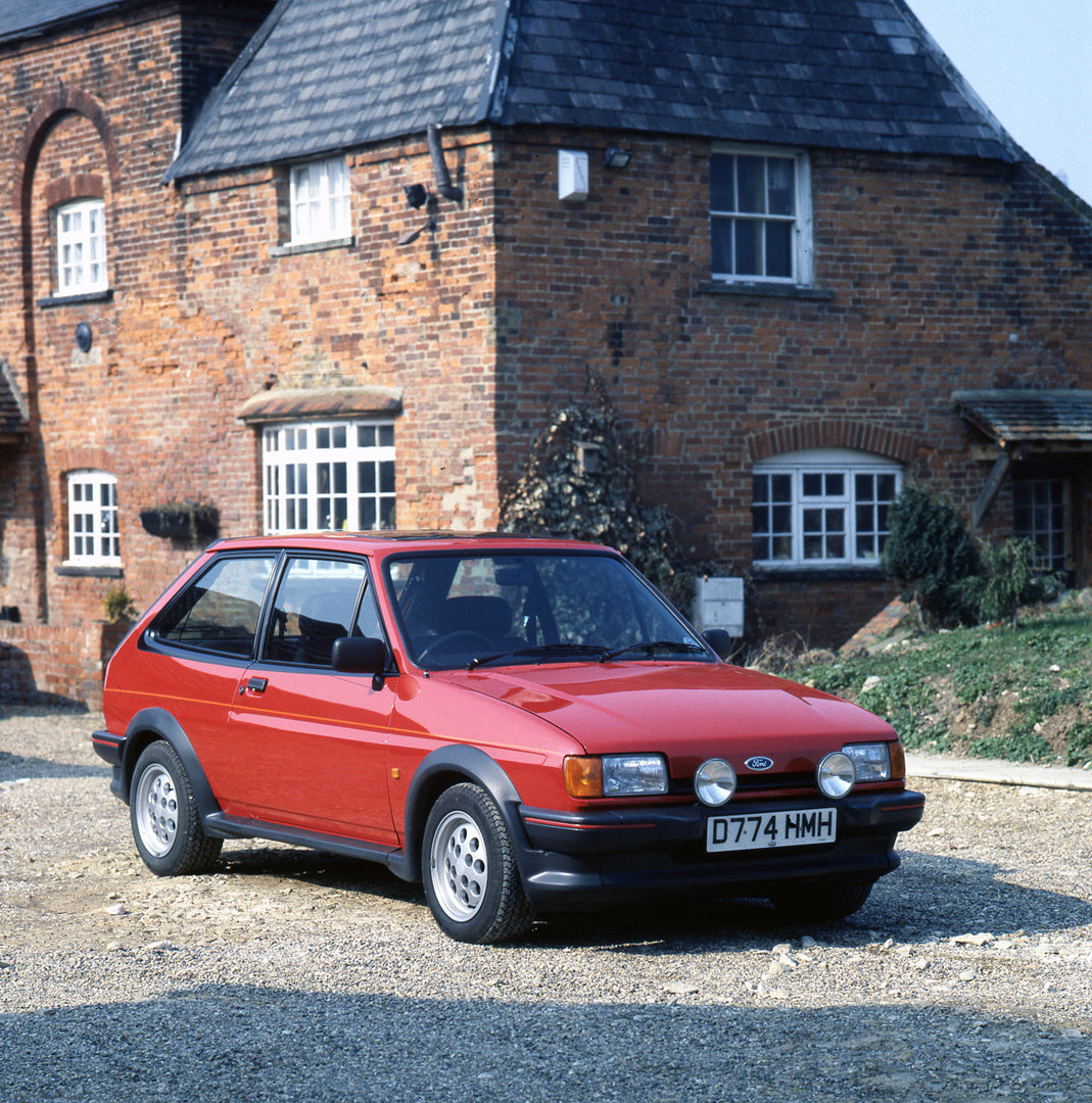 This archival image documents the 1987 Ford Fiesta Mark II XR2 in front of scenic brick house and is preserved in the Ford Heritage Vault as part of Ford Motor Company's historic photographic archive. Free for personal, non-commercial use. Ford He...