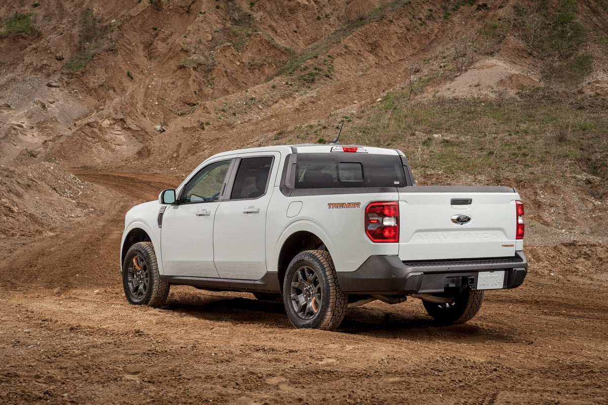 This archival image documents the 2023 Ford Maverick Tremor rear view on dirt road and is preserved in the Ford Heritage Vault as part of Ford Motor Company's historic photographic archive. Free for personal, non-commercial use. Ford Heritage Vaul...
