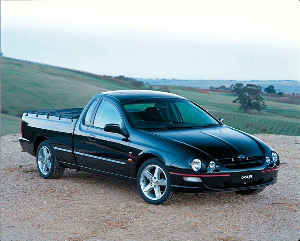 This archival image documents the 1999 Ford Falcon Ute on dirt road overlooking scenic field and is preserved in the Ford Heritage Vault as part of Ford Motor Company's historic photographic archive. Free for personal, non-commercial use. Ford Her...