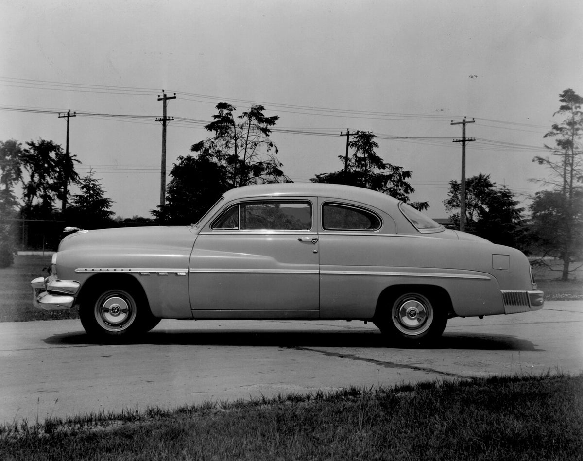 This archival image documents the 1951 Monarch Coupe side view on scenic road with trees AR-2007-5 and is preserved in the Ford Heritage Vault as part of Ford Motor Company's historic photographic archive. Free for personal, non-commercial use. Fo...