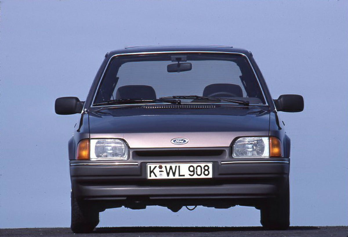 This archival image documents the 1986 Ford Escort Mark IV front view with scenic blue sky and is preserved in the Ford Heritage Vault as part of Ford Motor Company's historic photographic archive. Free for personal, non-commercial use. Ford Herit...