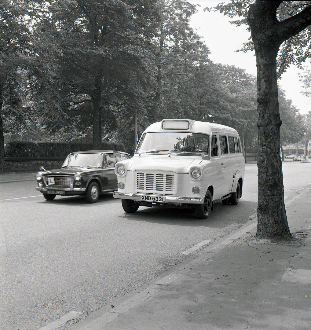 This archival image documents the 1973 Ford Transit Mark I Deansgate Safari Bus on scenic street and is preserved in the Ford Heritage Vault as part of Ford Motor Company's historic photographic archive. Free for personal, non-commercial use. Ford...