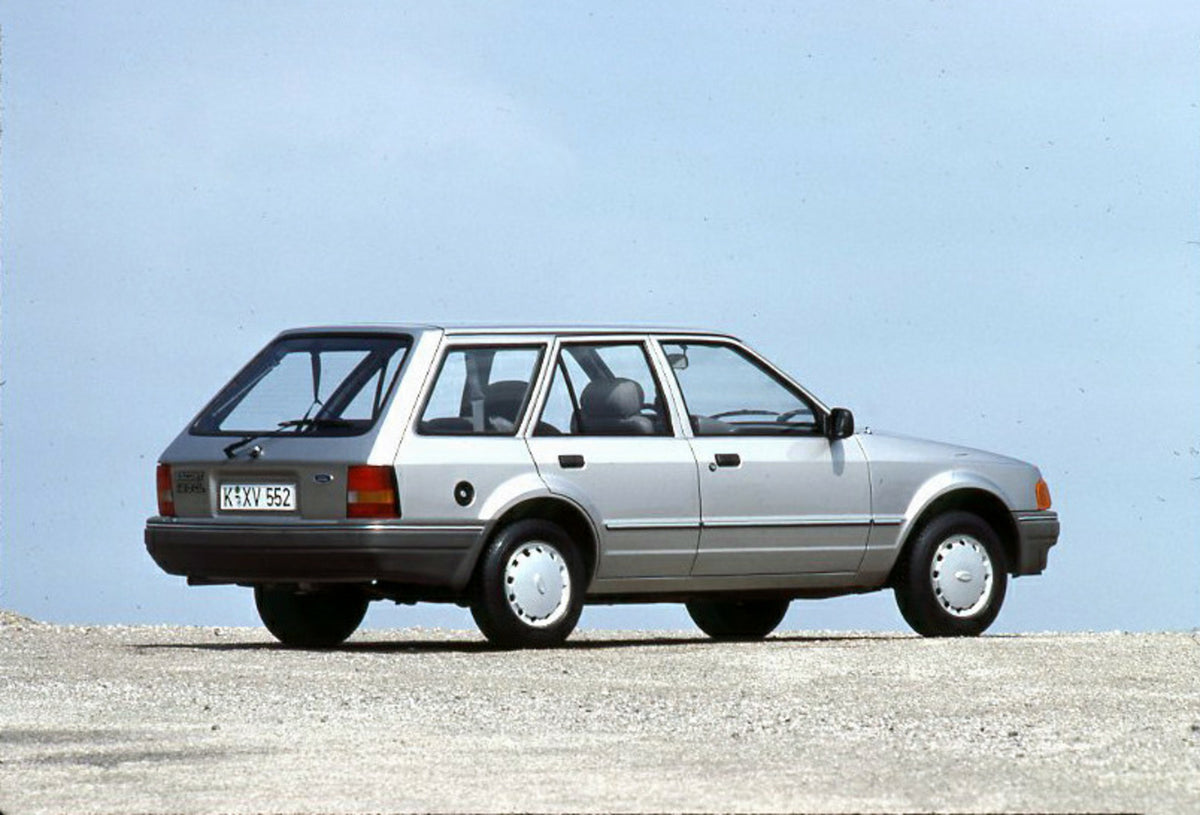 This archival image documents the 1986 Ford Escort Mark IV rear view with scenic blue sky and is preserved in the Ford Heritage Vault as part of Ford Motor Company's historic photographic archive. Free for personal, non-commercial use. Ford Herita...