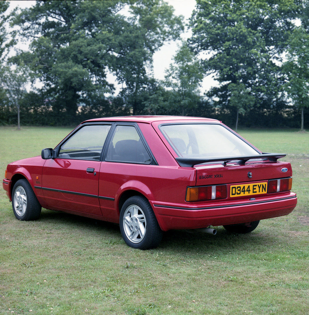 This archival image documents the 1986 Ford Escort Mark IV XR3i rear view in scenic field and is preserved in the Ford Heritage Vault as part of Ford Motor Company's historic photographic archive. Free for personal, non-commercial use. Ford Herita...