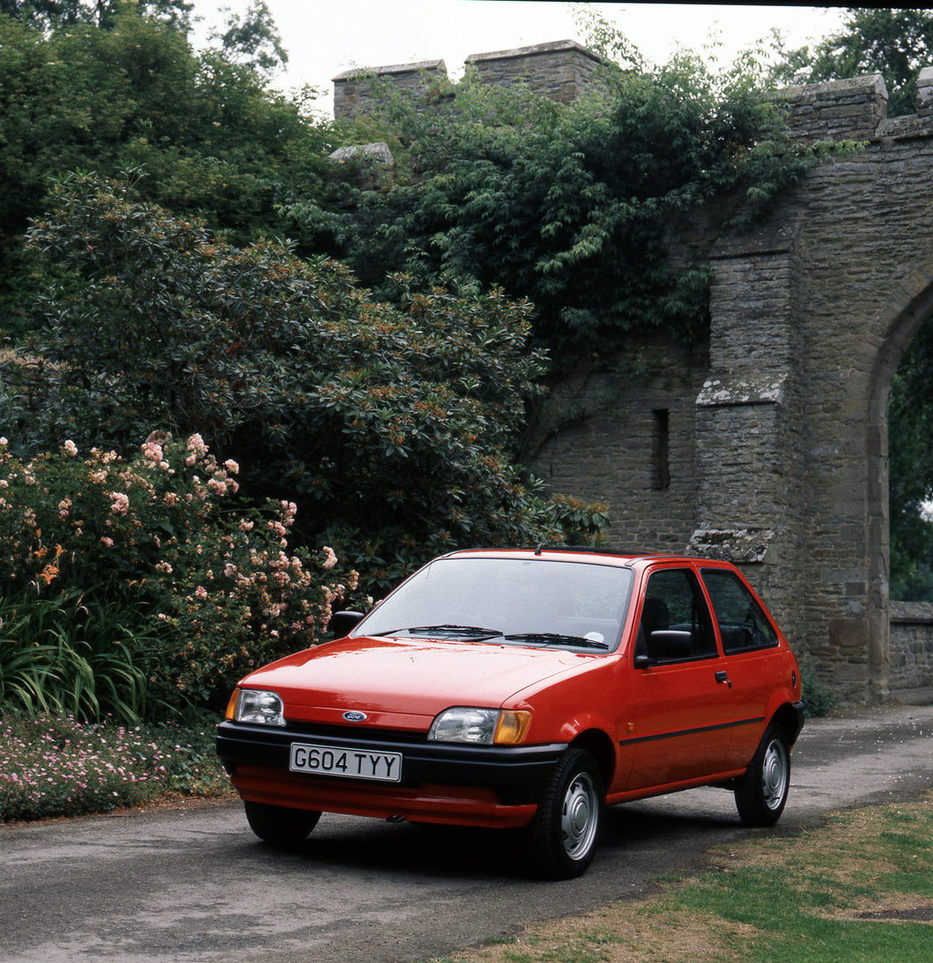 This archival image documents the 1989 Ford Fiesta Mark III 1.1 L in front of castle wall with scenic plants and is preserved in the Ford Heritage Vault as part of Ford Motor Company's historic photographic archive. Free for personal, non-commerci...