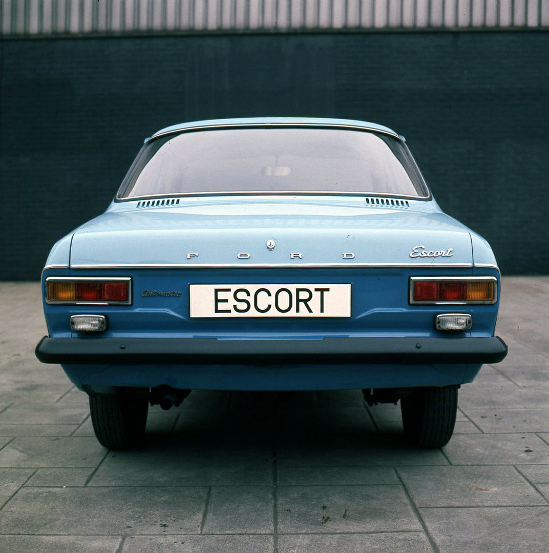 This archival image documents the 1974 Ford Escort Mark I LHD rear view on pavement and is preserved in the Ford Heritage Vault as part of Ford Motor Company's historic photographic archive. Free for personal, non-commercial use. Ford Heritage Vau...