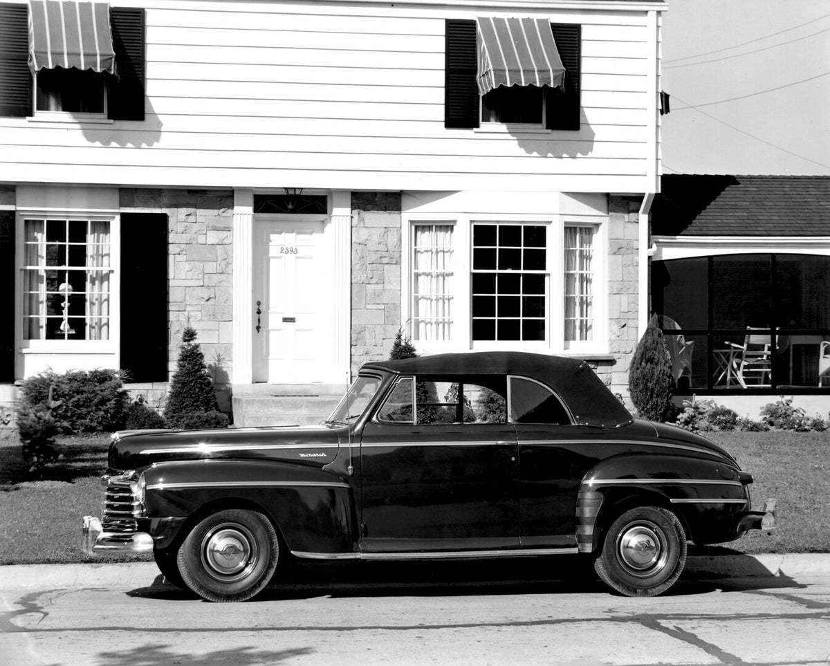 This archival image documents the 1946 Monarch Convertible side view in front of house AR-2007-5 and is preserved in the Ford Heritage Vault as part of Ford Motor Company's historic photographic archive. Free for personal, non-commercial use. Ford...