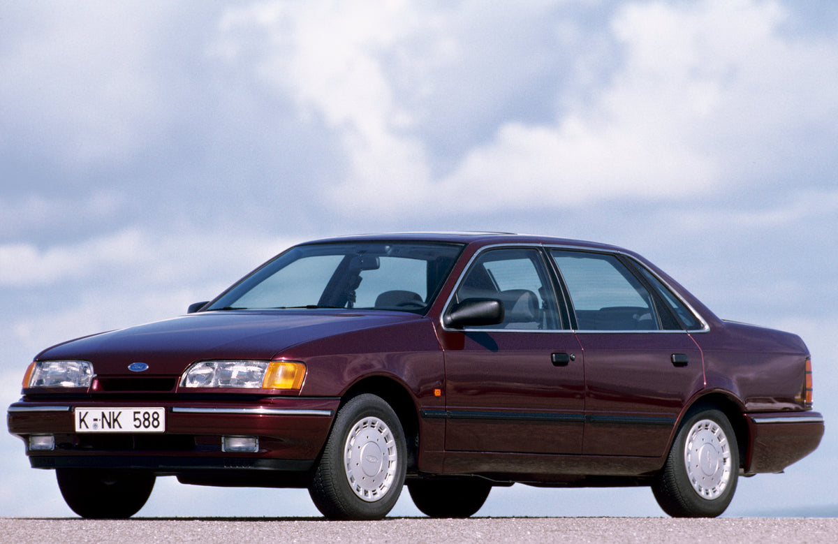 This archival image documents the 1990 Ford Scorpio Mark I with scenic blue sky and is preserved in the Ford Heritage Vault as part of Ford Motor Company's historic photographic archive. Free for personal, non-commercial use. Ford Heritage Vault r...