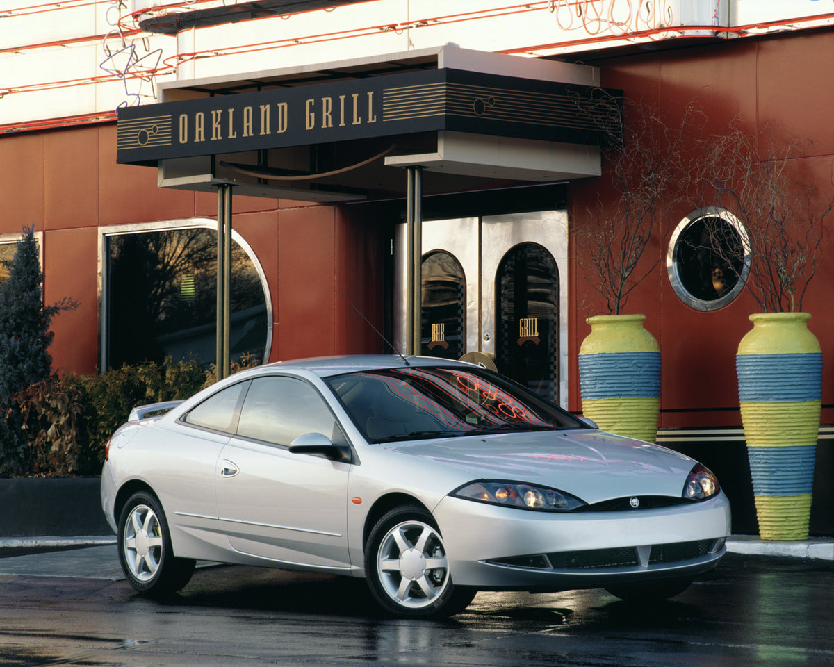 This archival image documents the 1999 Mercury Cougar in Front of Oakland Grill and is preserved in the Ford Heritage Vault as part of Ford Motor Company's historic photographic archive. Free for personal, non-commercial use. Ford Heritage Vault r...