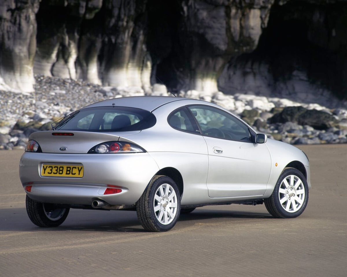 This archival image documents the 2001 Ford Puma rear view on scenic road with cave and is preserved in the Ford Heritage Vault as part of Ford Motor Company's historic photographic archive. Free for personal, non-commercial use. Ford Heritage Vau...