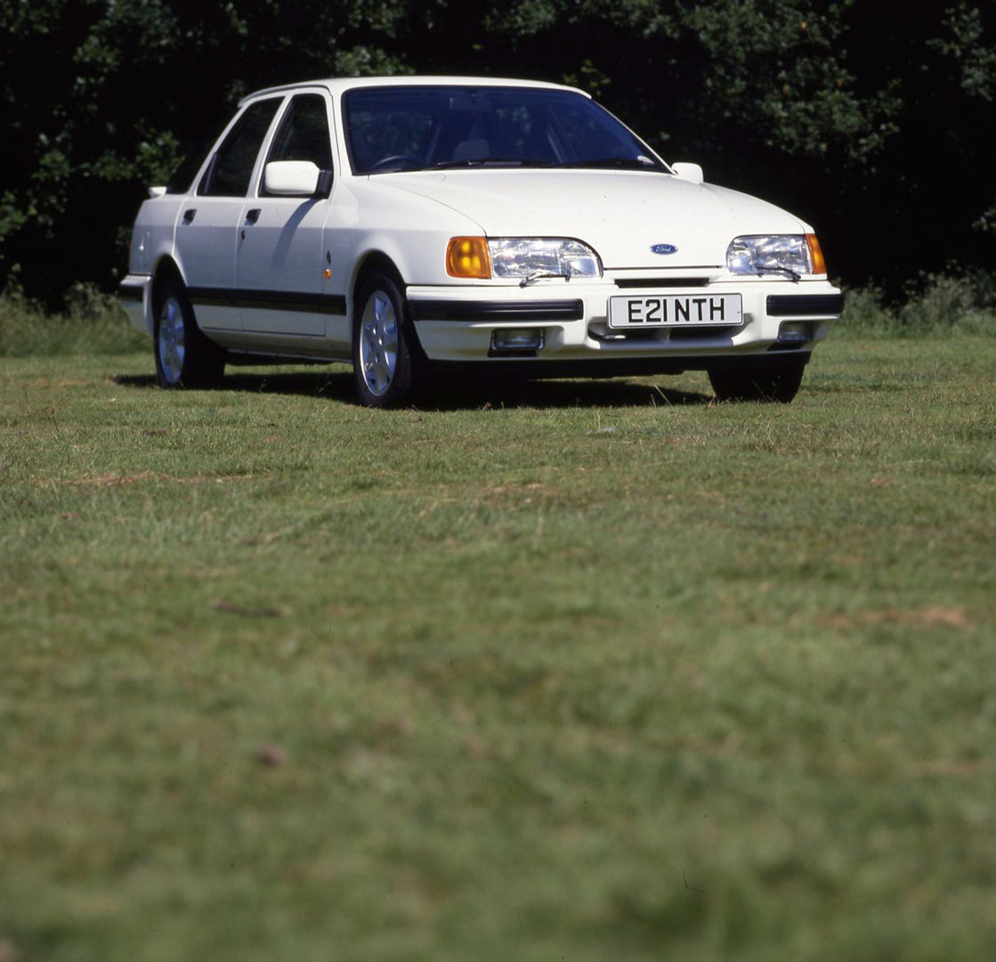 This archival image documents the 1987 Ford Sierra Mark II XR 4x4 in scenic field with trees and is preserved in the Ford Heritage Vault as part of Ford Motor Company's historic photographic archive. Free for personal, non-commercial use. Ford Her...