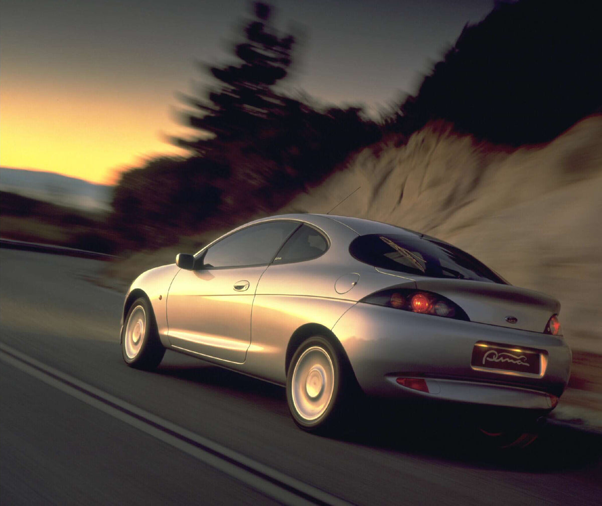 This archival image documents the 1997 Ford Puma rear view action shot on scenic road AR-2002-213709 and is preserved in the Ford Heritage Vault as part of Ford Motor Company's historic photographic archive. Free for personal, non-commercial use. ...