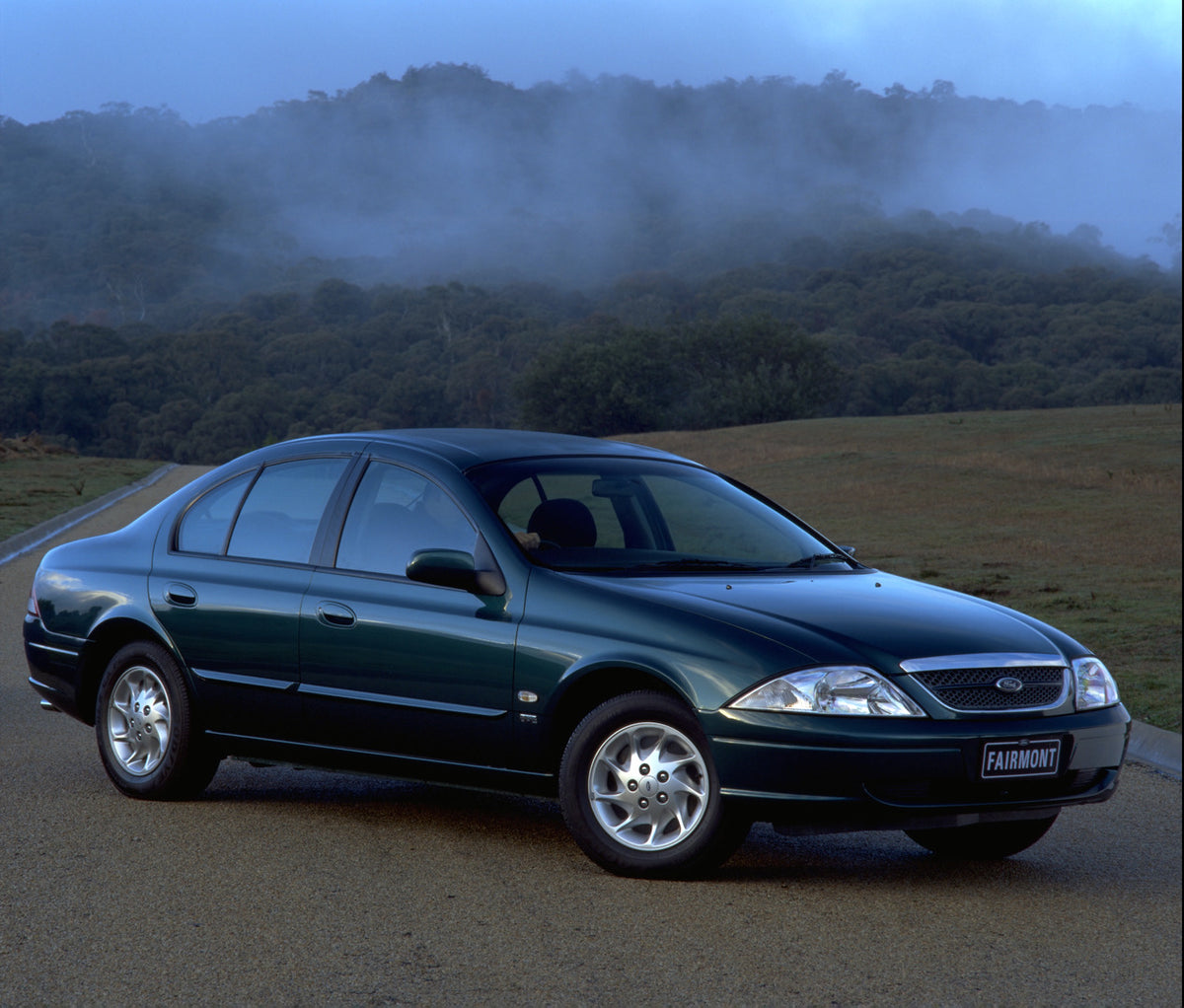 This archival image documents the 1998 Ford Falcon Fairmont on scenic road with trees and mist and is preserved in the Ford Heritage Vault as part of Ford Motor Company's historic photographic archive. Free for personal, non-commercial use. Ford H...