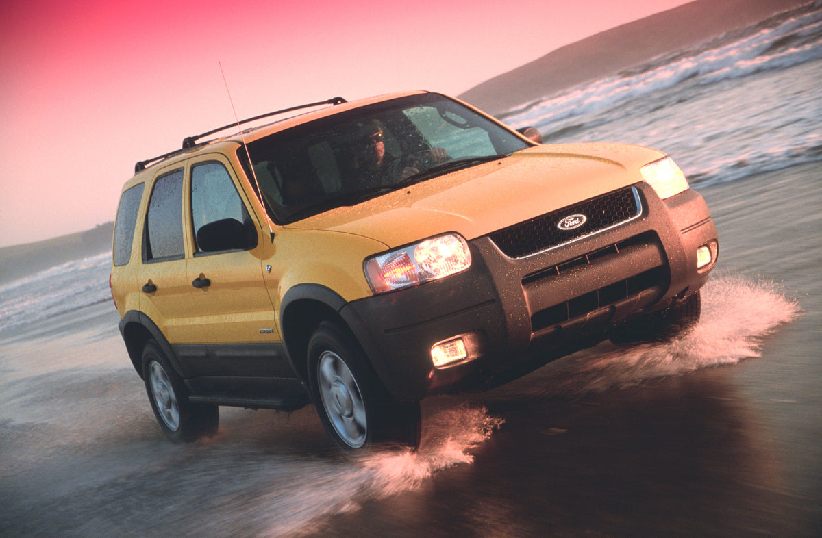 This archival image documents the 2001 Ford Escape driving through water and is preserved in the Ford Heritage Vault as part of Ford Motor Company's historic photographic archive. Free for personal, non-commercial use. Ford Heritage Vault referenc...
